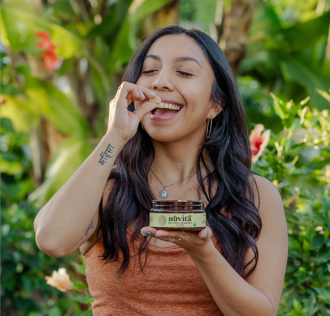 Woman eating a gummy in a natural tropical background