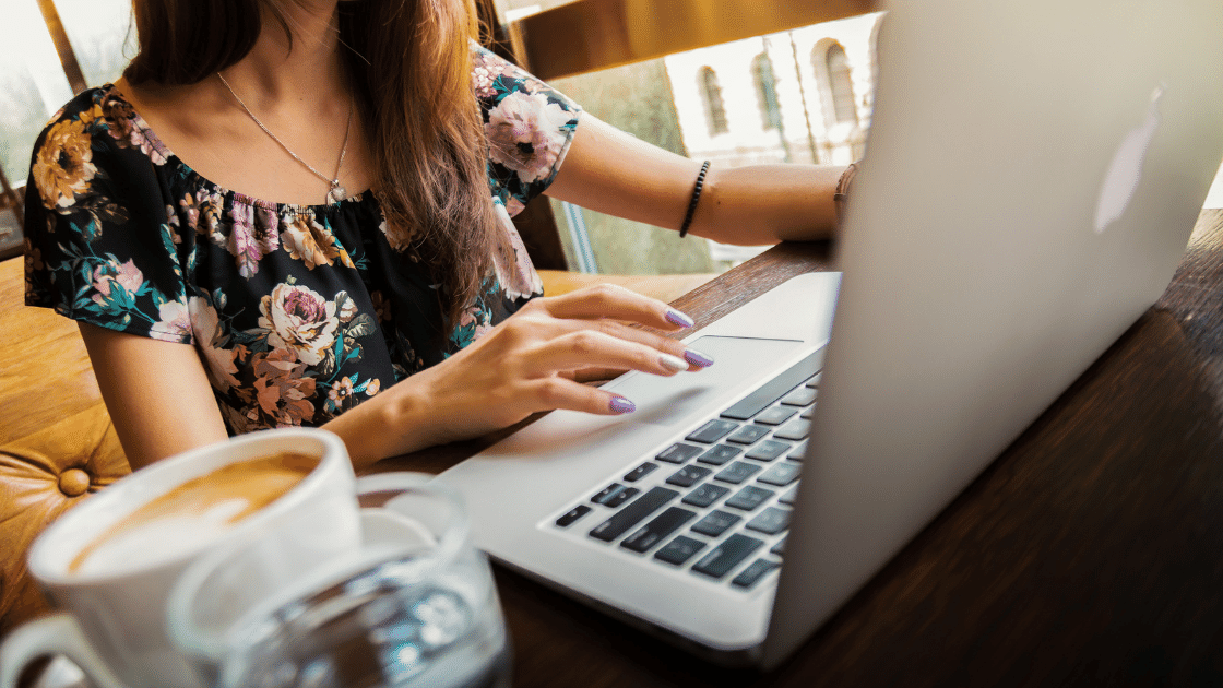 Woman working on a laptop in a coffee shop